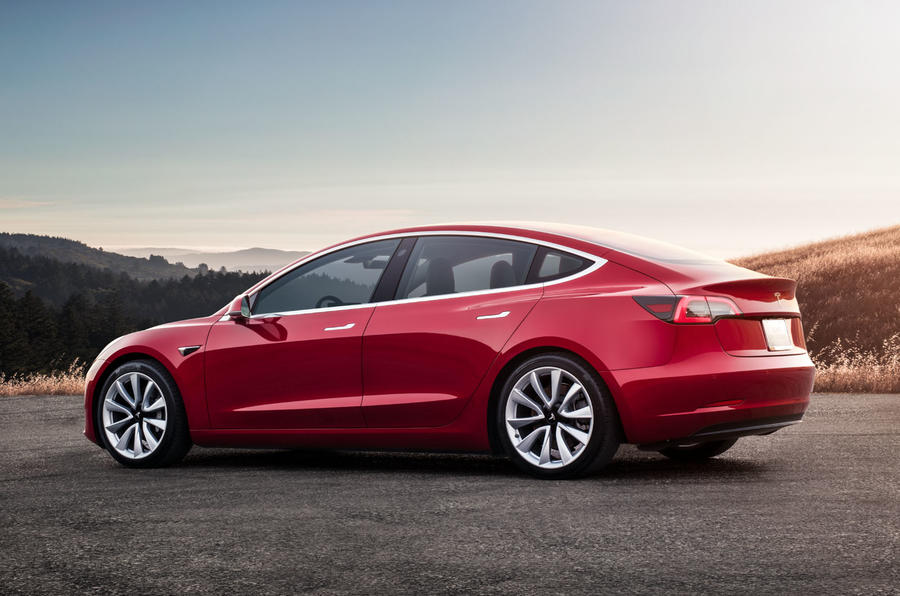 aria-label="model 3 red rear sunset"