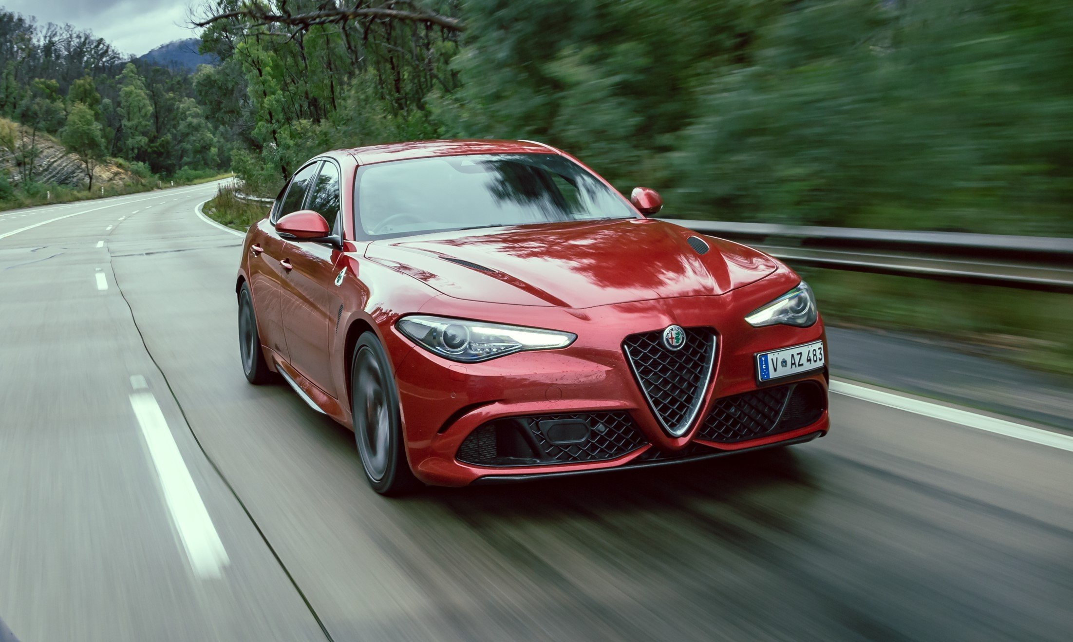 aria-label="Alfa Romeo Stelvio Q red front tracking driving"